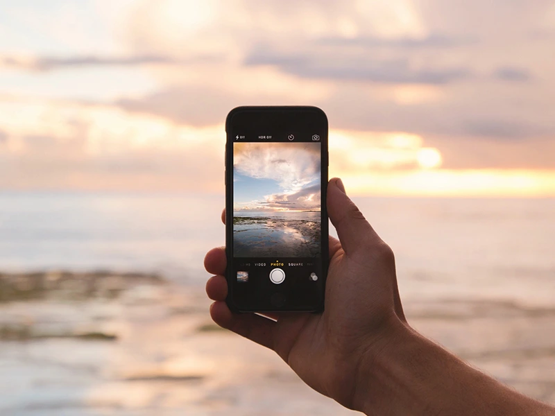 telefoon strand zonsondergang fotograferen camera