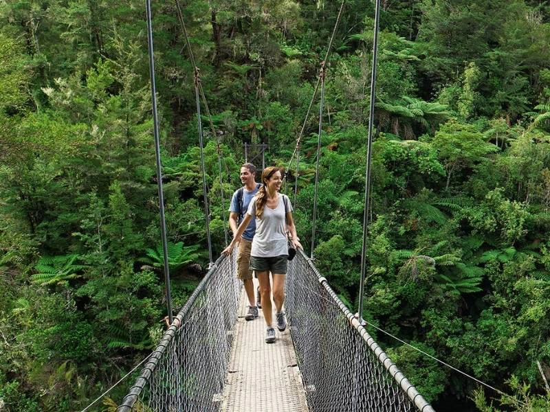 twee mensen op een hangbrug in het regenwoud