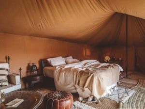 Bed in glamping tent in Agafay