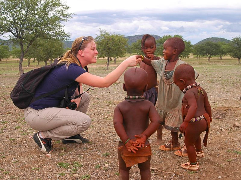 Vrouw ontmoet Himba kinderen